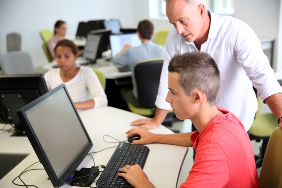 Business school students in class with teacher
