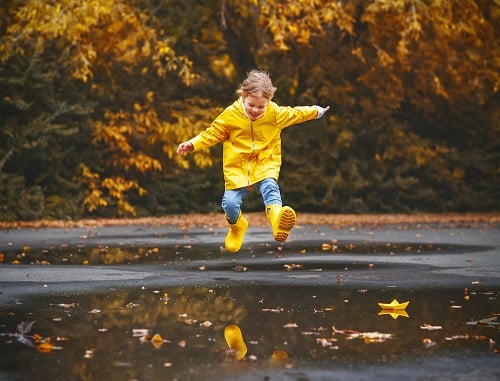 Girl Splashing in Puddle