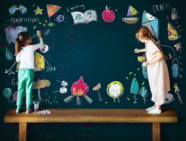 Girls Drawing on Chalkboard
