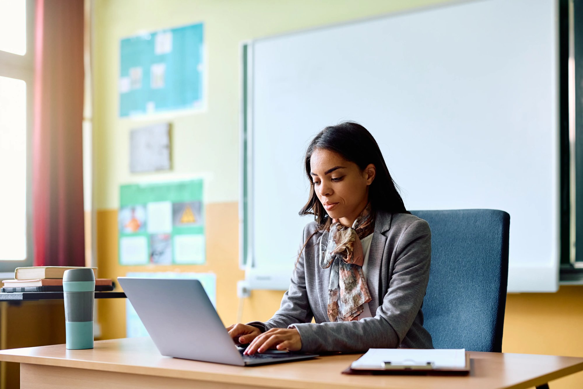 african american woman at a desk working on a laptop