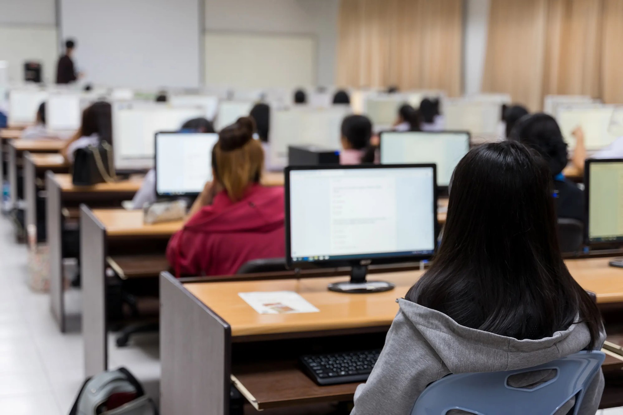 students in classroom looking at computer screens