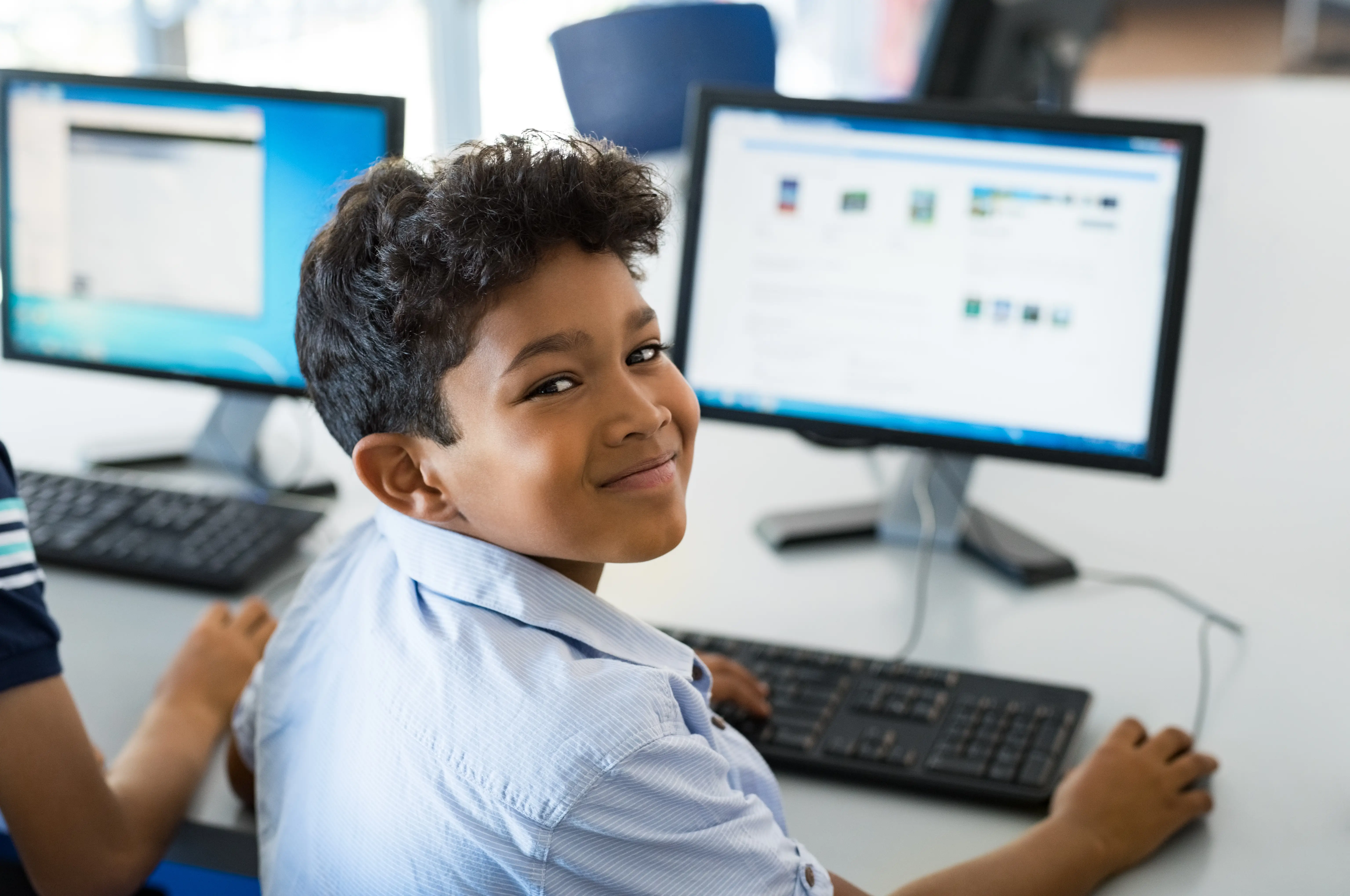 Boy smiling while at computer